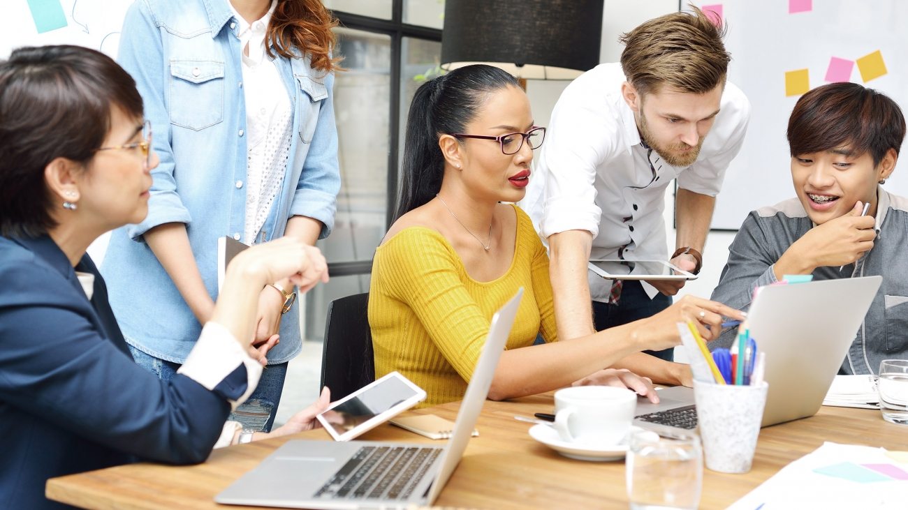 Group of businesspersons having different age in creative business discussing work in the office